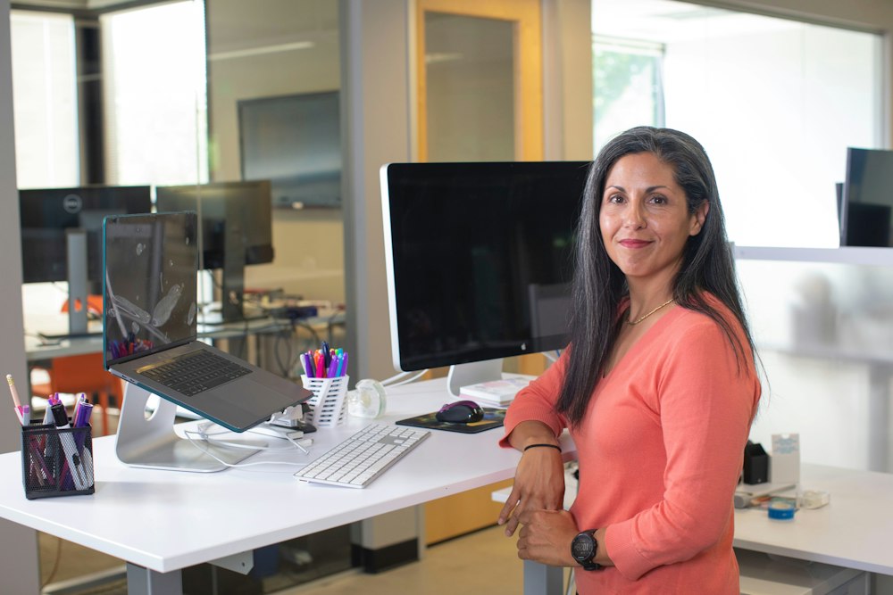 A smiling professional at her desk